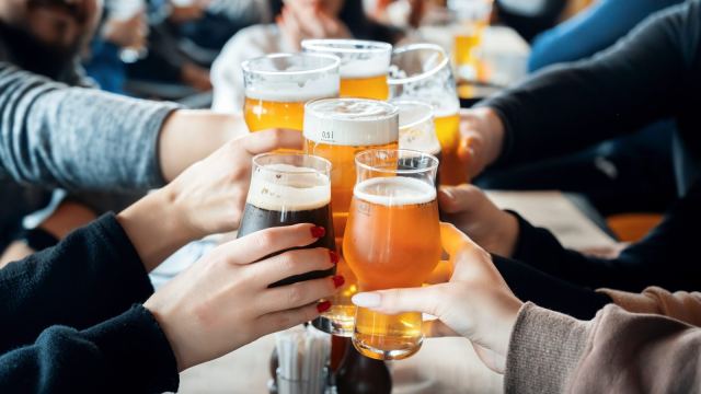 Group of people clinking glasses with beer